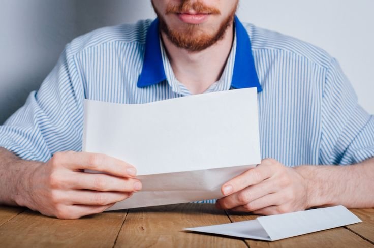 a man reading a compensation recovery (CRU) letter